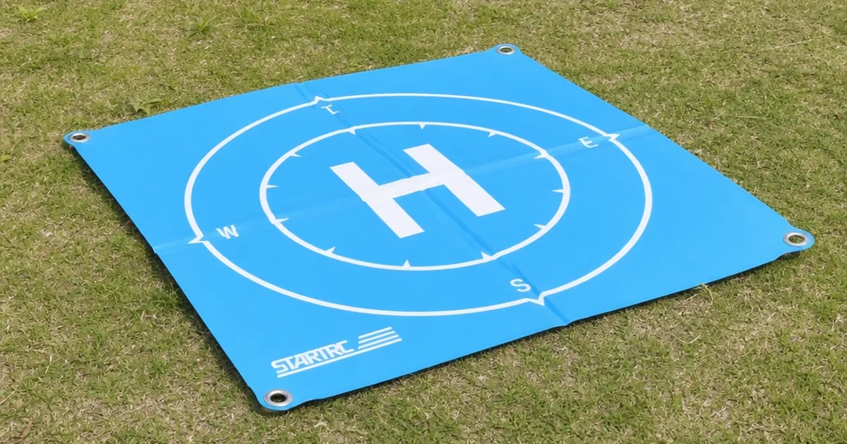 Square blue drone landing pad with printed landing marks placed on an outdoor surface